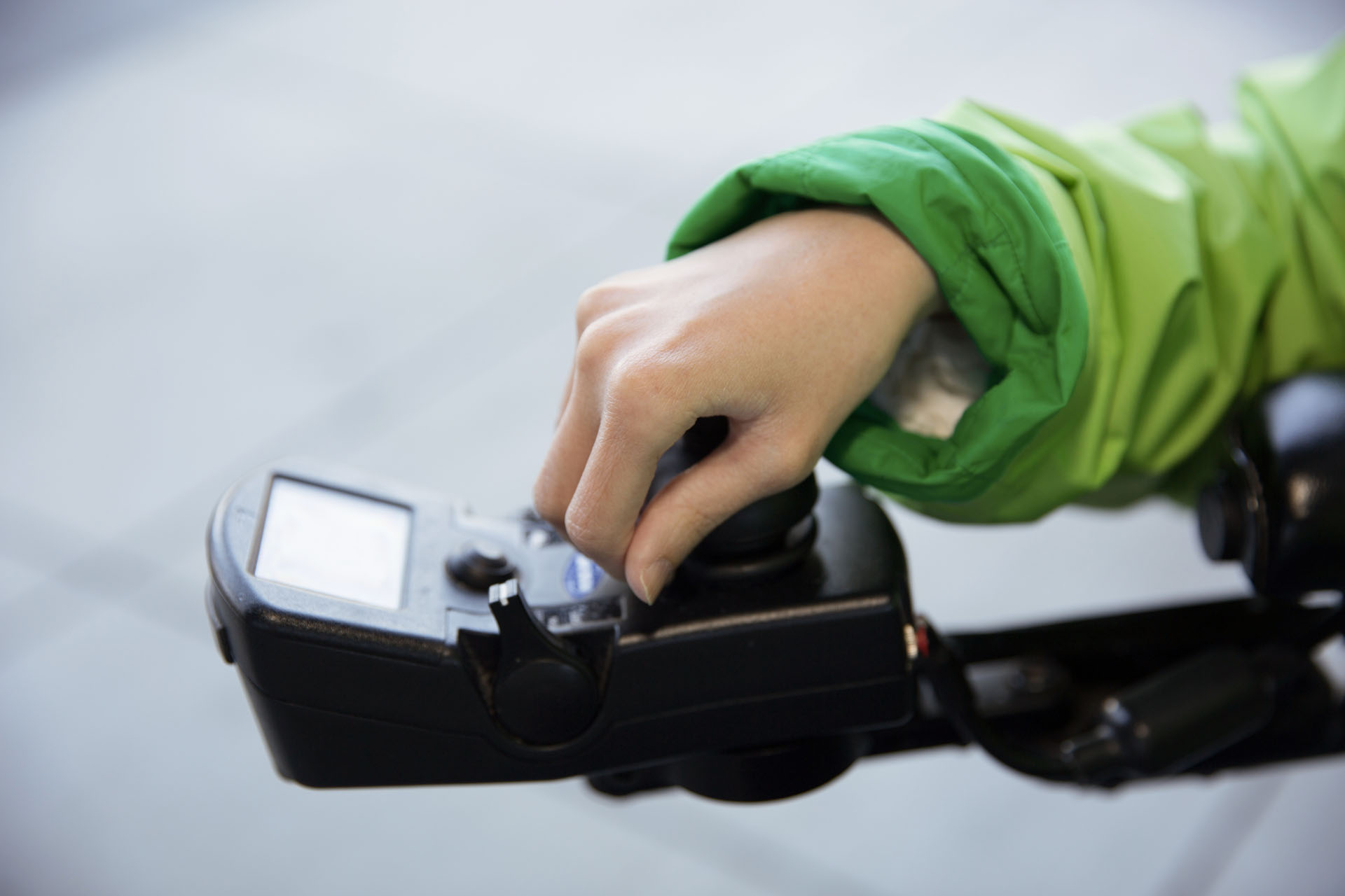 Alice Wong, former UCSF staff research associate in Social and Behavioral Sciences and a disabilities advocate, has her hand on the controls for her motorized wheelchair.